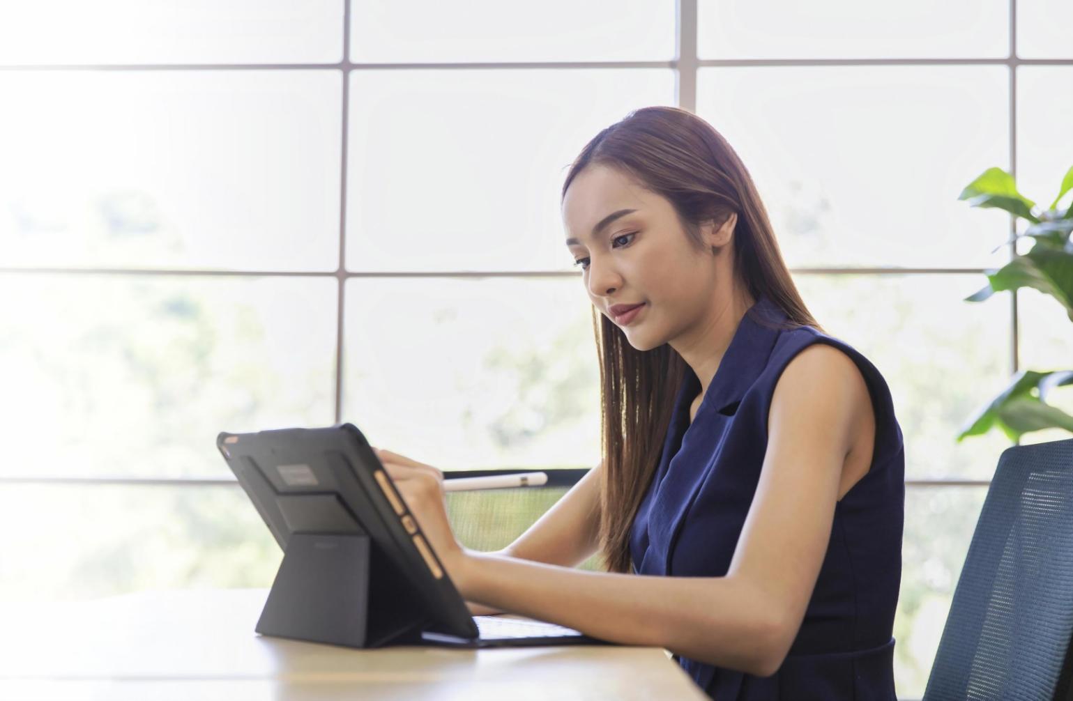 Modern office environment with financial professionals analyzing market data on multiple screens